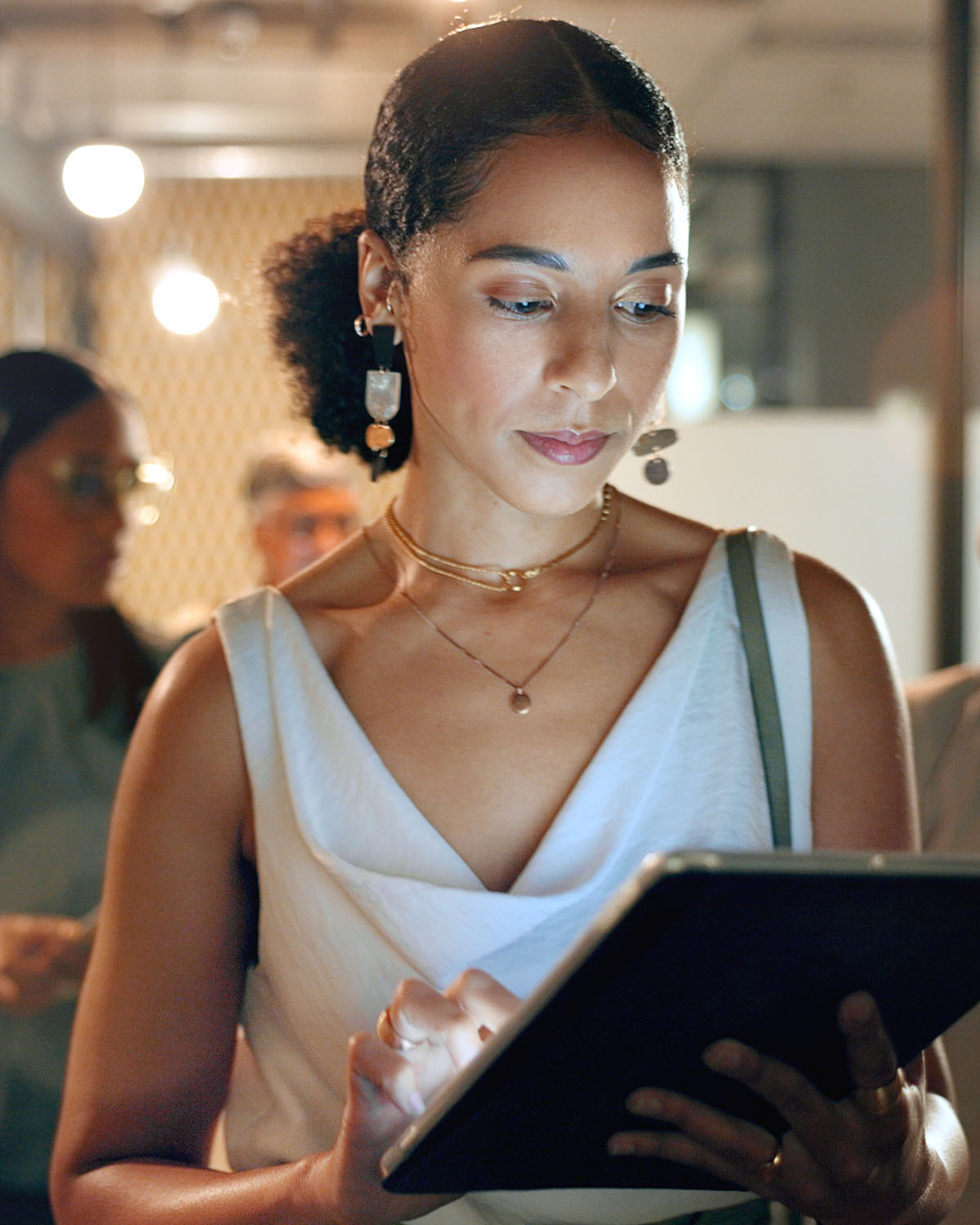 Image of a woman on a tablet ready to take advamtage of The Vault,  complete implementation engine designed to build your "Low-Key" authority with zero overwhelm.